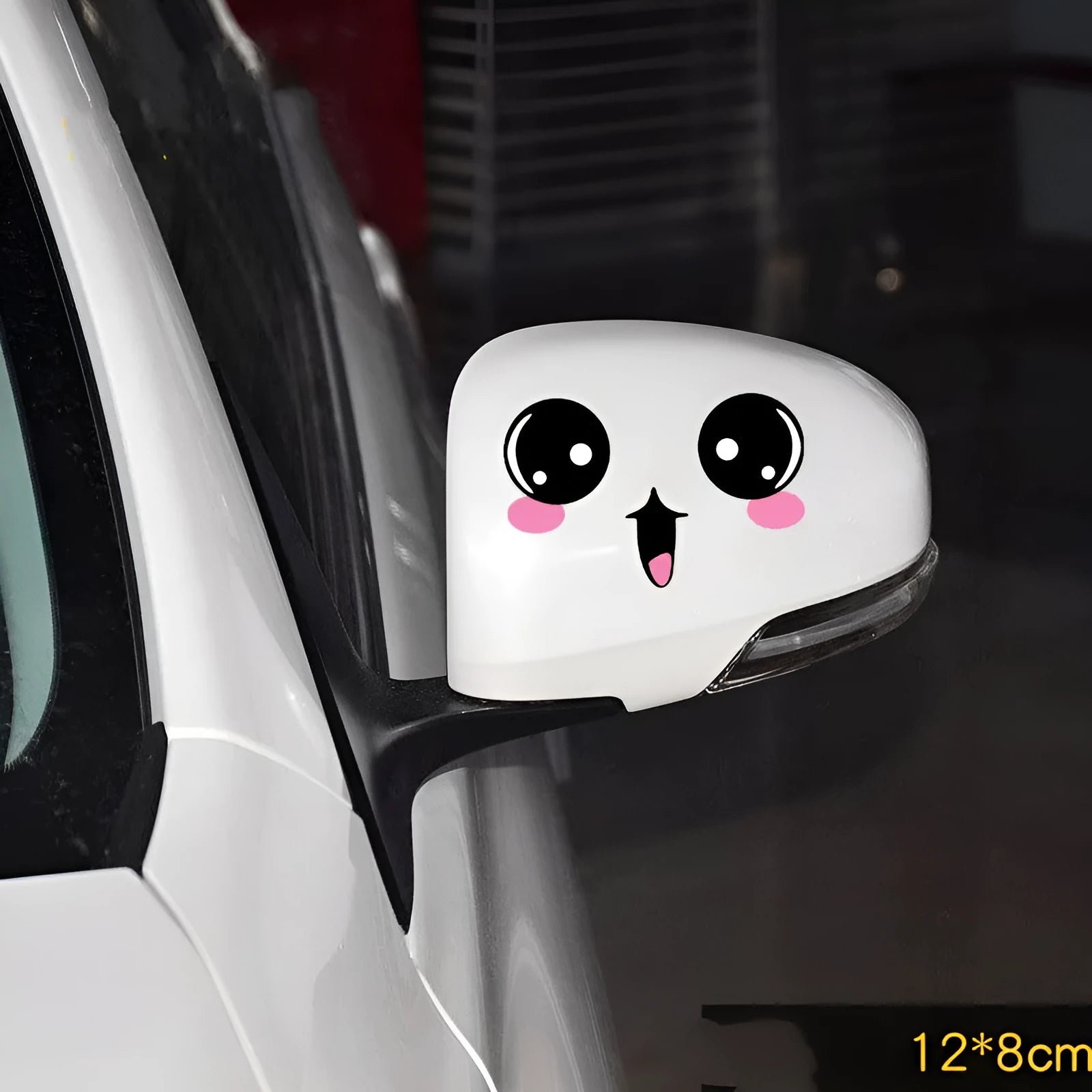 A pair of reflective cartoon eye car stickers on a vehicle rearview mirror.