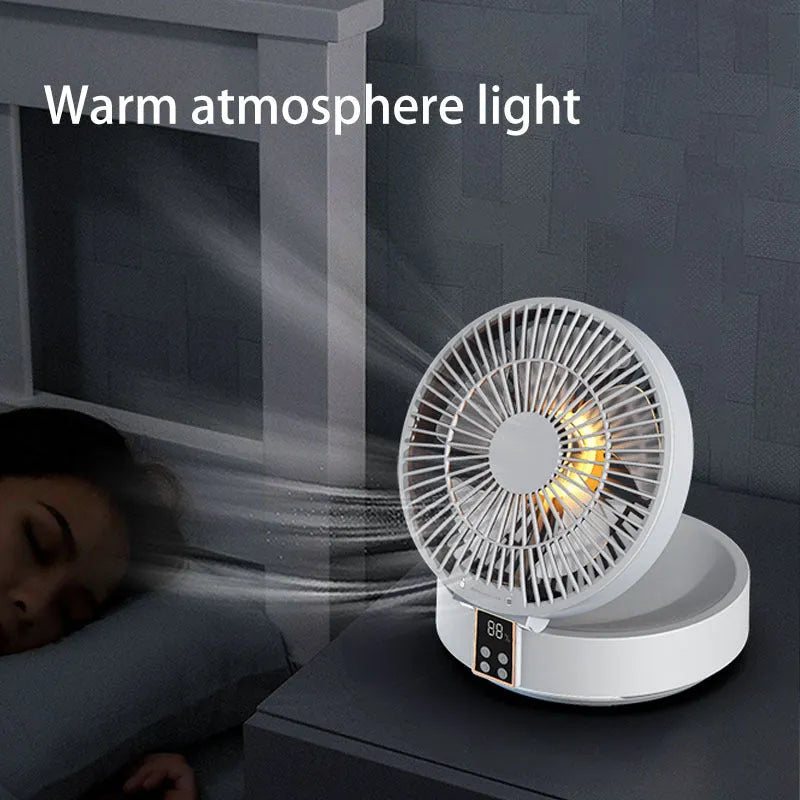 White portable USB rechargeable folding desk fan with remote control on wooden surface