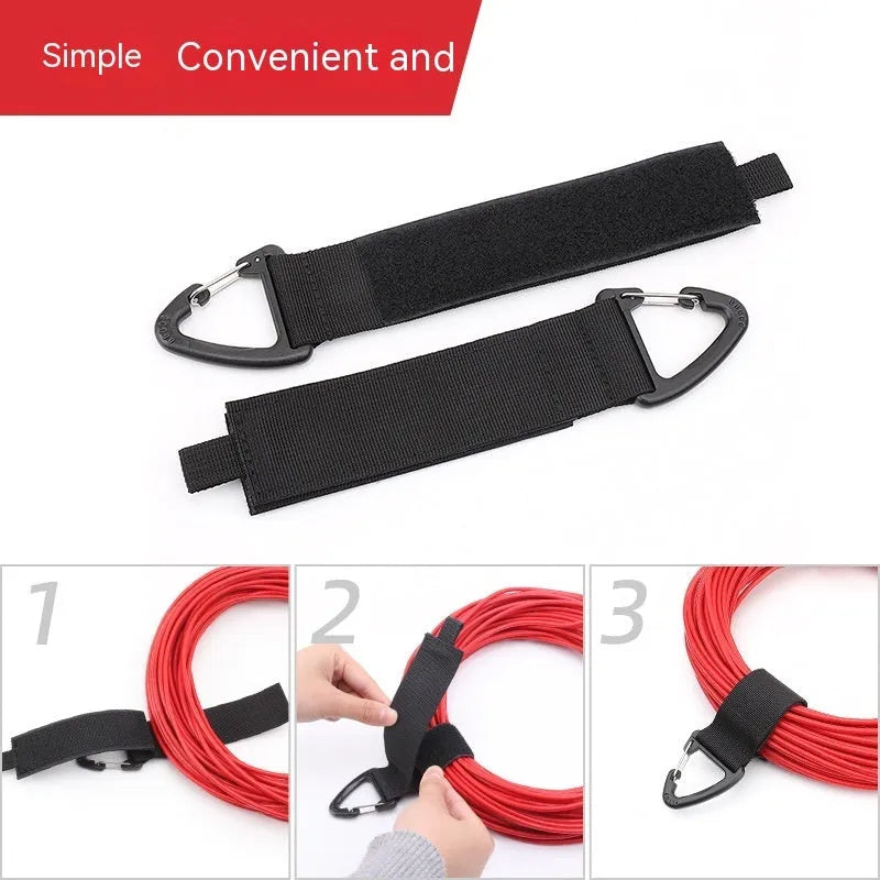 Black heavy-duty adjustable storage strap with metal carabiner clip for garage workshop organisation.