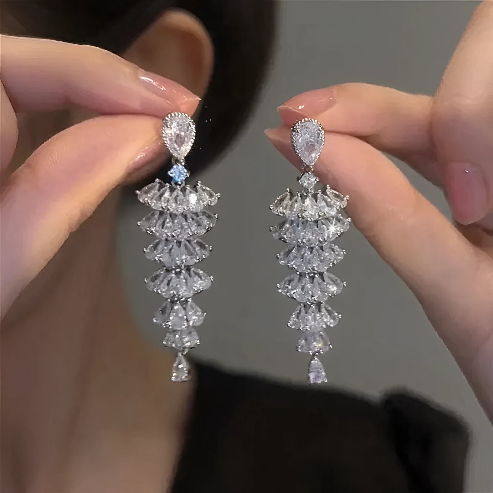 Silver pagoda Christmas tree drop earrings with sparkling zircon crystals on copper studs.