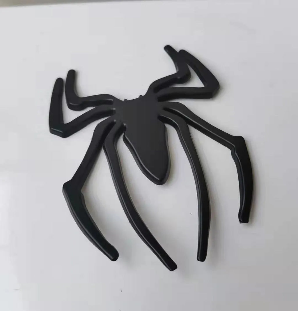 3D metallic spider bumper sticker in gold, silver, black, and red colour options.