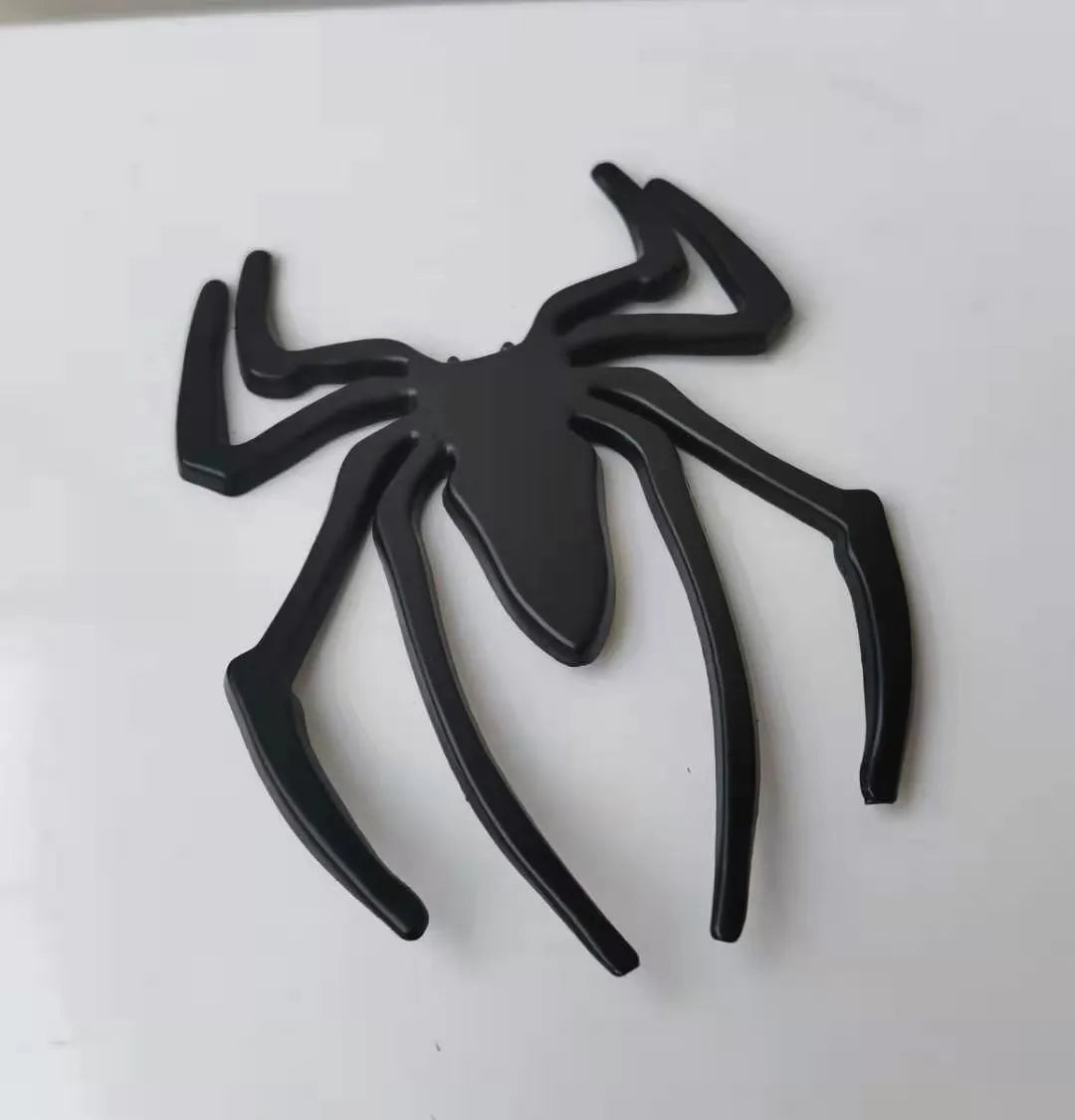 3D metallic spider bumper sticker in gold, silver, black, and red colour options.