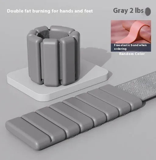 Detachable silicone weight training bracelet with Velcro strap in black, showing 1lb or 2lb weight option.