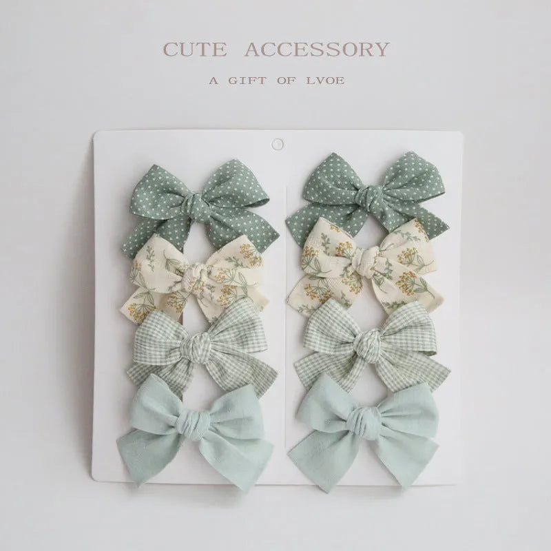 Children's fabric dovetail bow hair clips in eight pattern options
