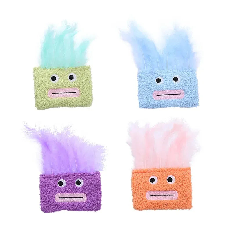 Colourful cat plush toy with a big mouth explosion head shape on a plain background.