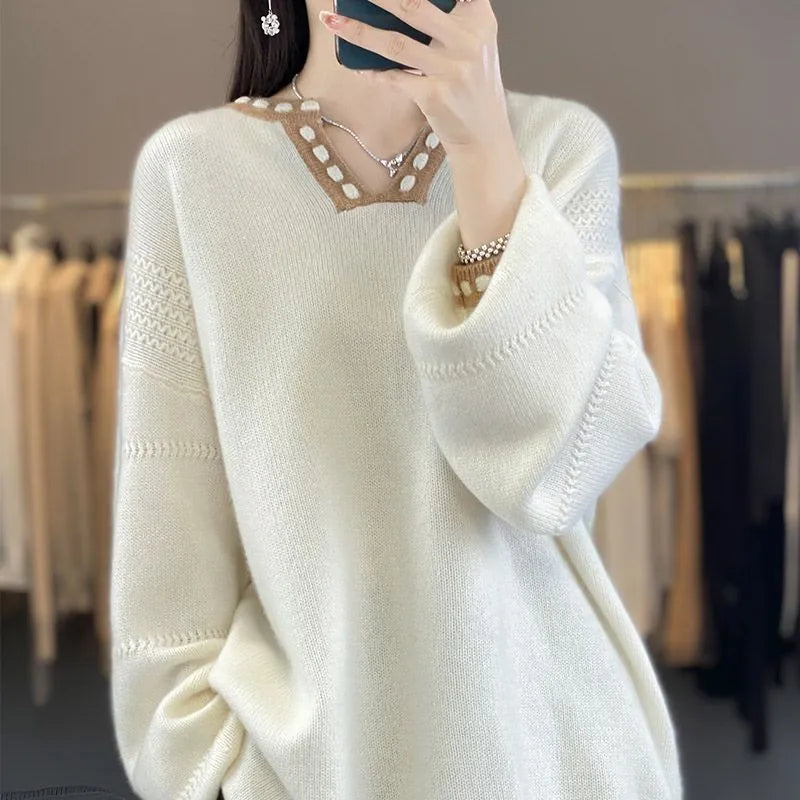 Women's camel coloured V-neck viscose pullover sweater with long sleeves on a hanger.