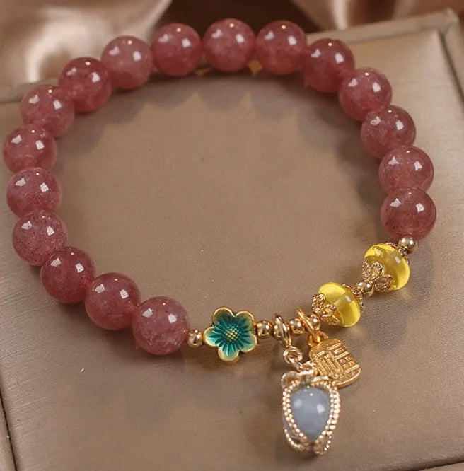 Red strawberry quartz and rhinestone beaded bracelet with an alloy clasp.