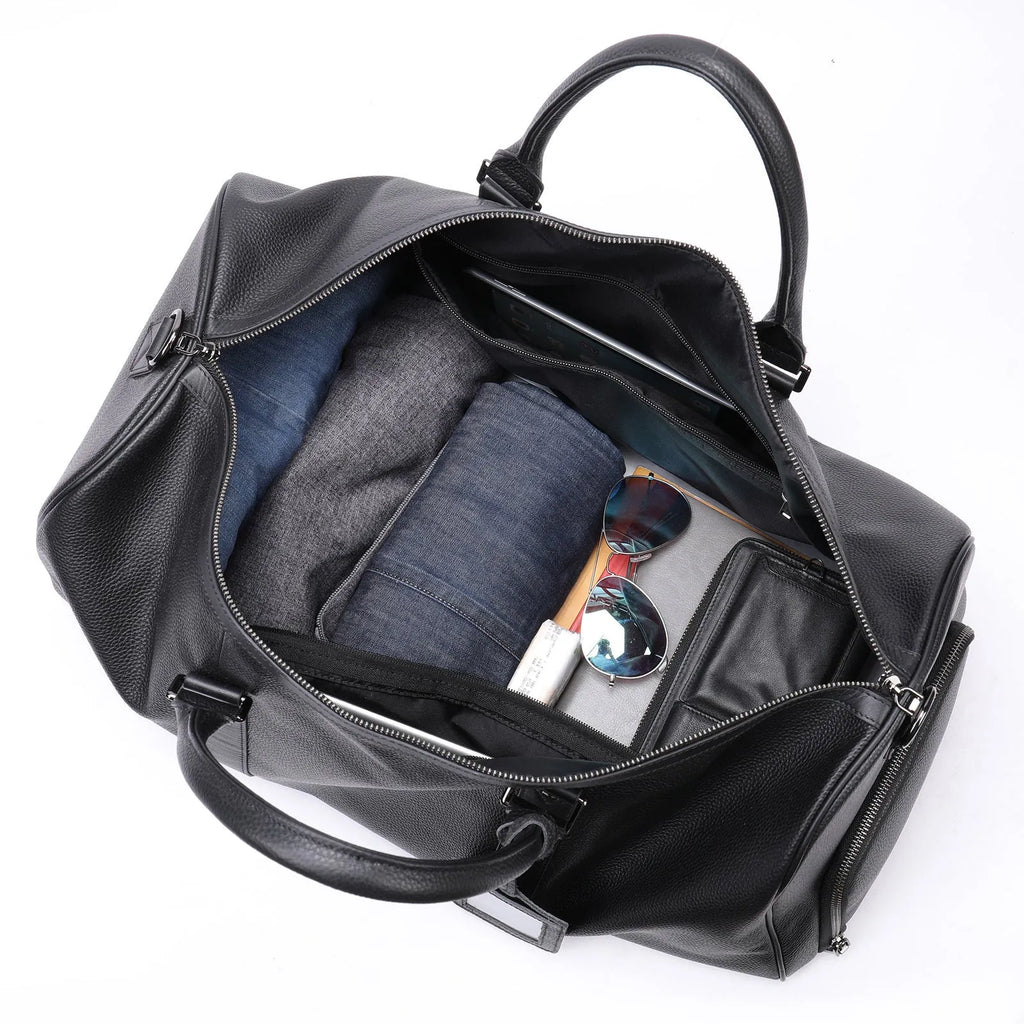 Men's black leather excursion tote bag with single strap showing 55cm large capacity dimensions