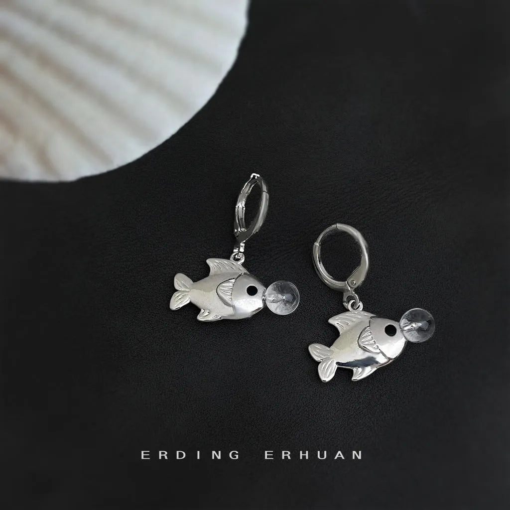 A pair of copper bubble fish earrings with goldfish elements and an electroplated finish.