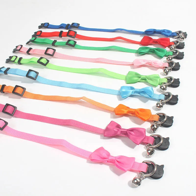 Adjustable nylon cat collar with decorative bow and bell in multiple colour options including red, blue, pink and green