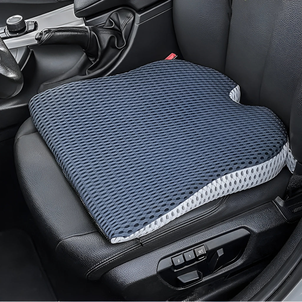 Solid colour memory foam cushion with an attached strap, shown on a car seat.