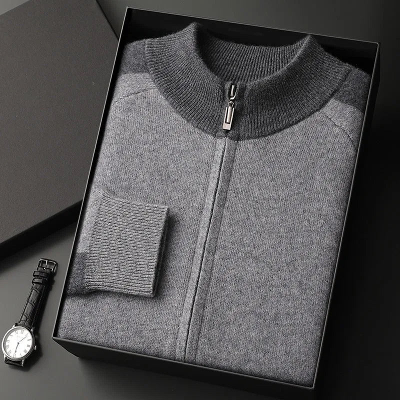 Men's navy blue cashmere blend knitted cardigan suit with half turtleneck and zip, paired with matching trousers.