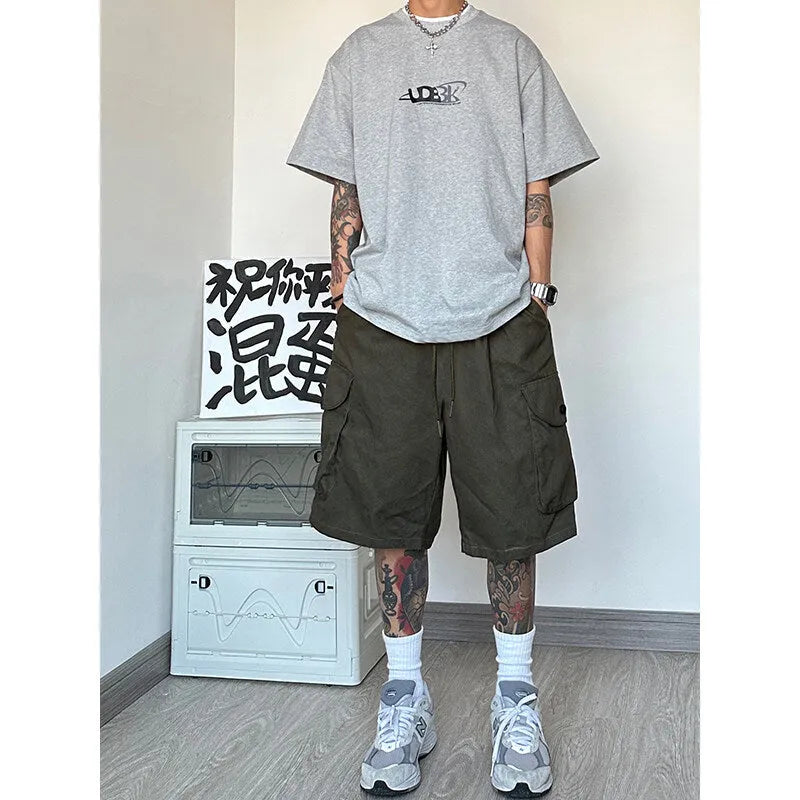Man wearing loose straight-leg casual shorts in blue, showing the relaxed fit and straight cut.
