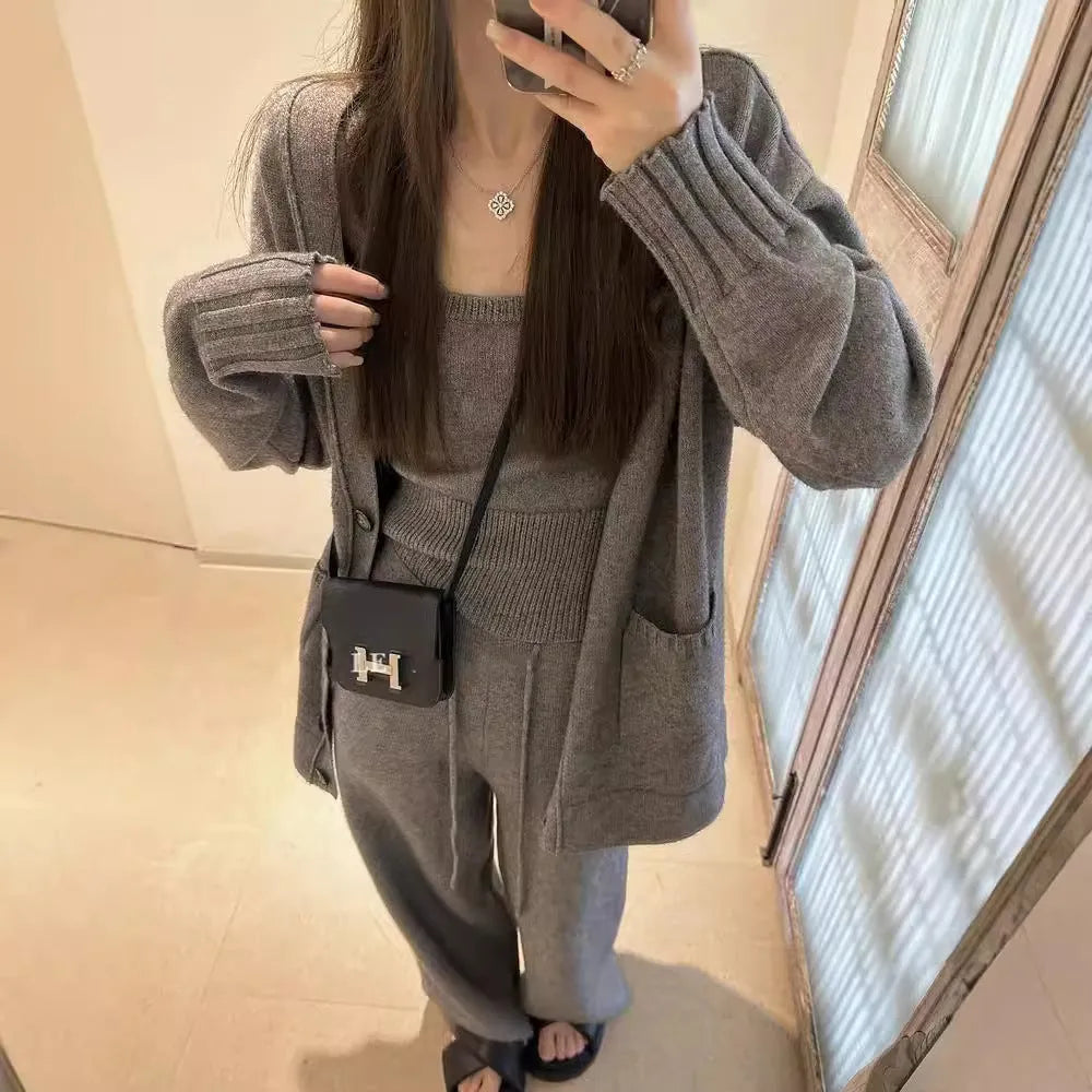 Women's loose fit knit cardigan, vest, and casual pants three-piece set in a solid colour.