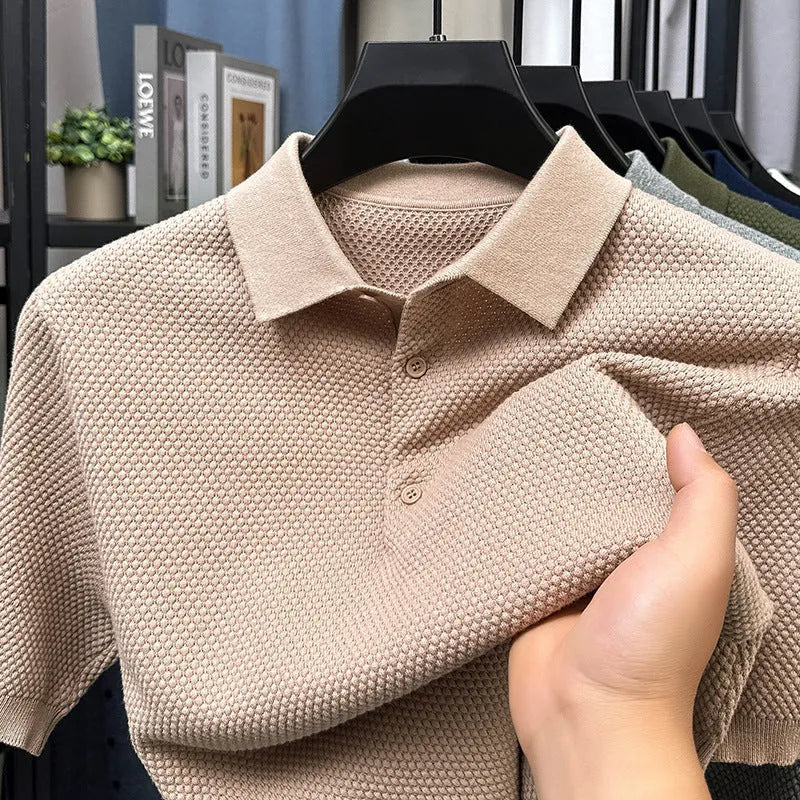 Man wearing a loose fit short sleeve cotton sweater in grey, showing the pullover style and relaxed silhouette.