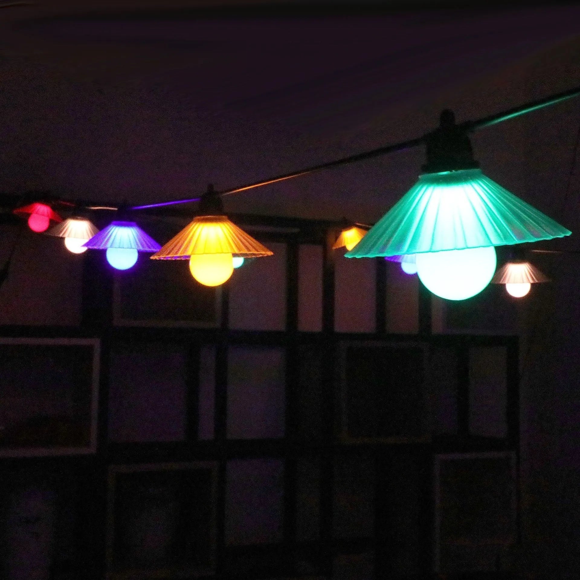 Outdoor LED string lights with flower-shaped bulbs in warm white and colour options.