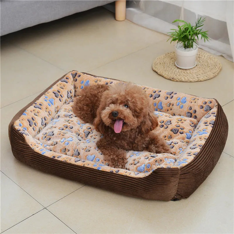 Beige plush sofa-style pet bed for small dogs with a raised bolster edge, shown in a home setting.