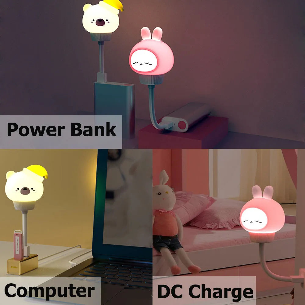 Small cartoon bear-shaped USB night light with remote control on a bedside table.