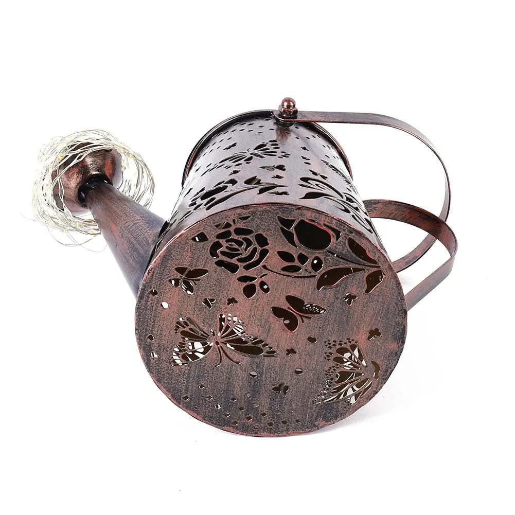 Solar garden lamp with tapered butterfly silhouette design in iron construction