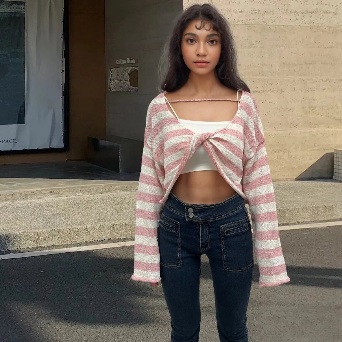 A woman's striped long-sleeve pullover sweater with a front and back wearable design in mercerised cotton.