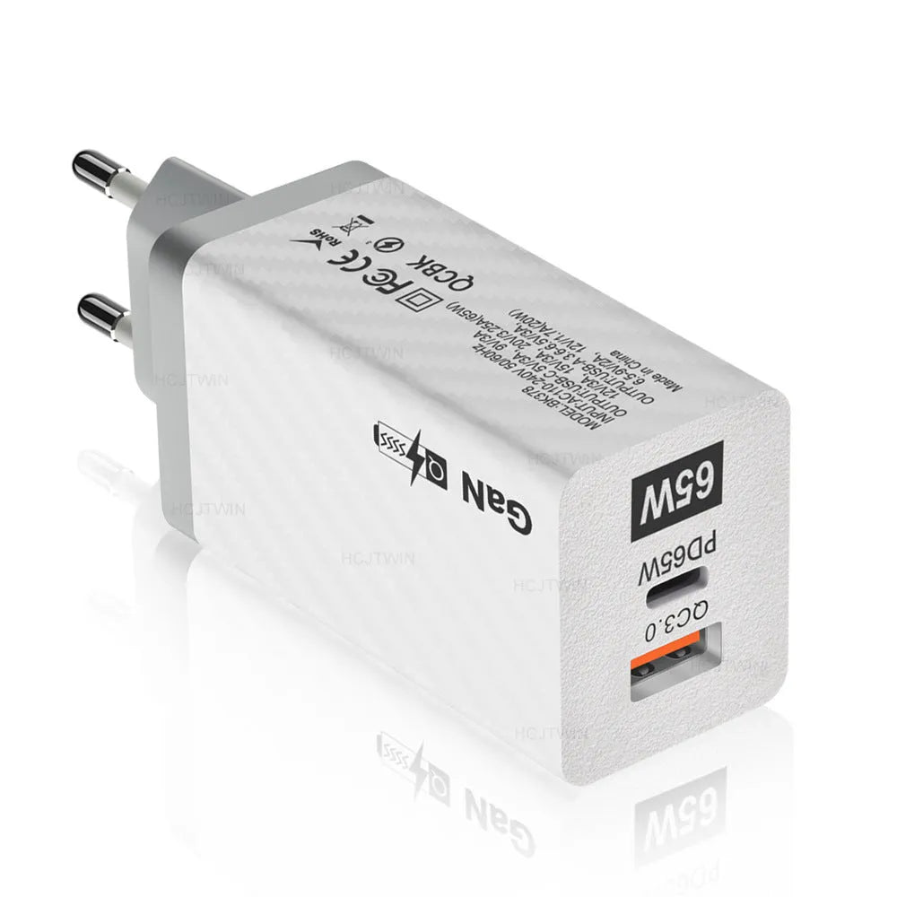 White Gallium Nitride 65W laptop charger with EU UK US plugs showing compact size