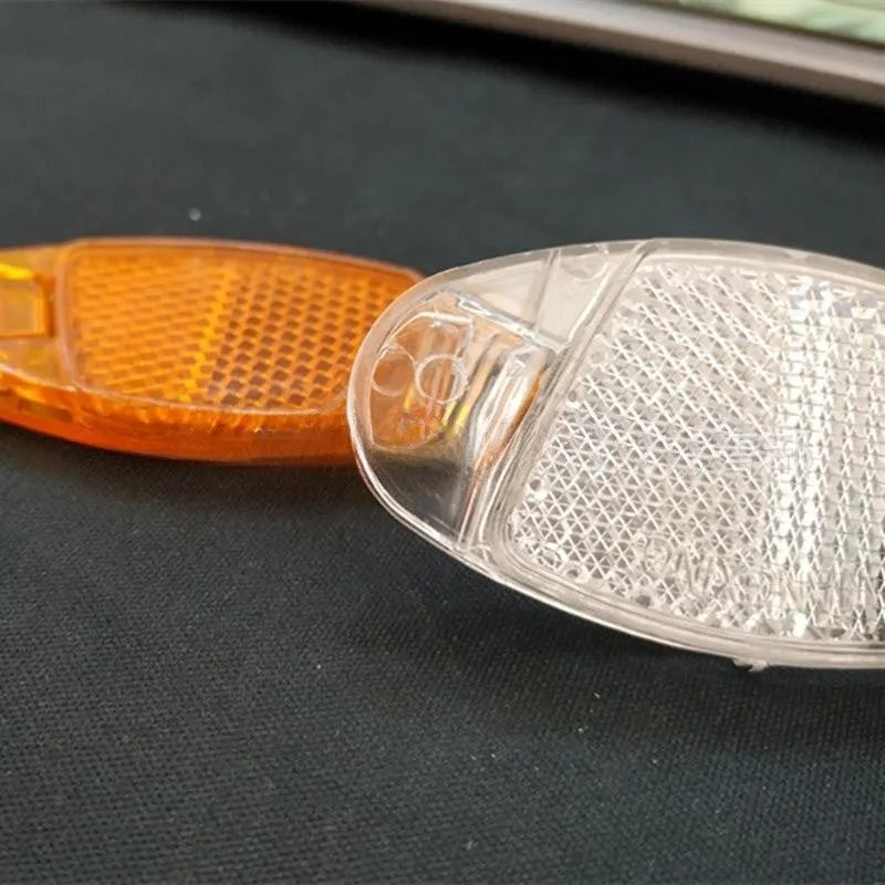 Bicycle plastic spoke reflector measuring 7.2cm by 3.5cm in white or yellow colour for front and rear wheel safety