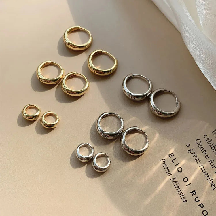 Women's geometric water drop earrings in gold and silver with minimalist round design