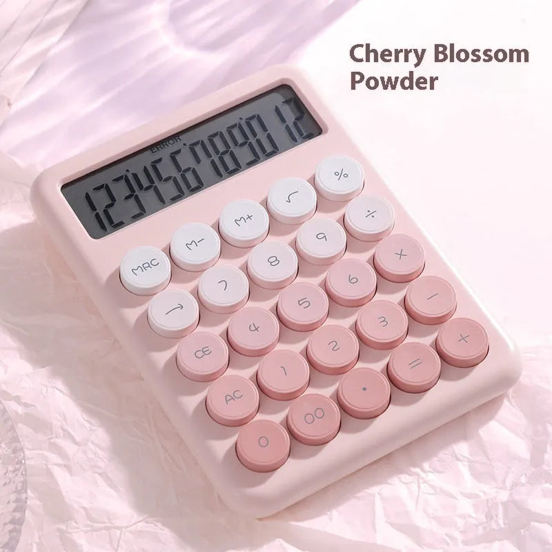 Violet, blue, green, and pink gradient colour desktop calculator on a desk.
