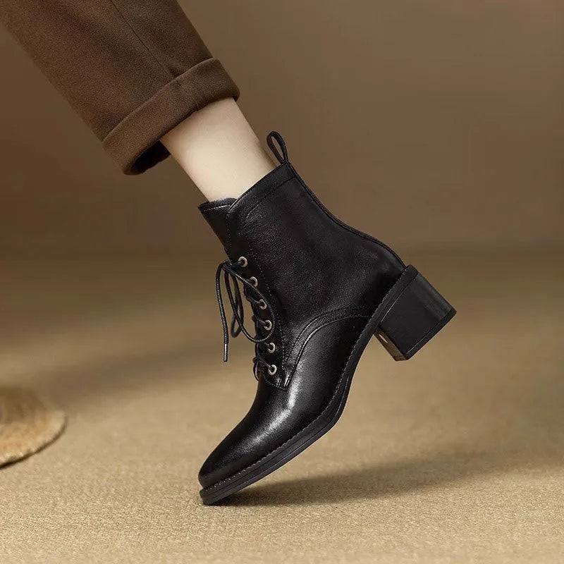 Women's black pointed-toe short ankle boots with a 5.5cm heel on a plain background.