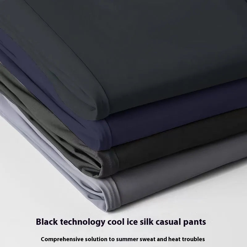 Man wearing black Ice Silk straight-leg loose trousers with an elasticated waist for leisure.