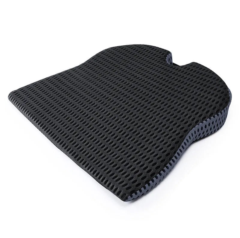 Solid colour memory foam cushion with an attached strap, shown on a car seat.