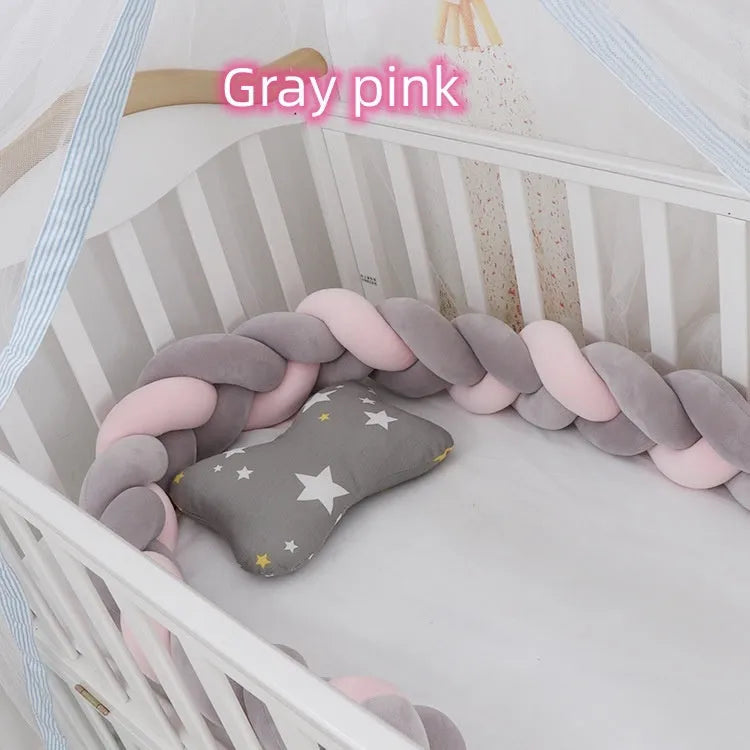 Bendable braid-knot baby crib bumper in spandex velvet, shown in a light grey colour wrapped around a cot.