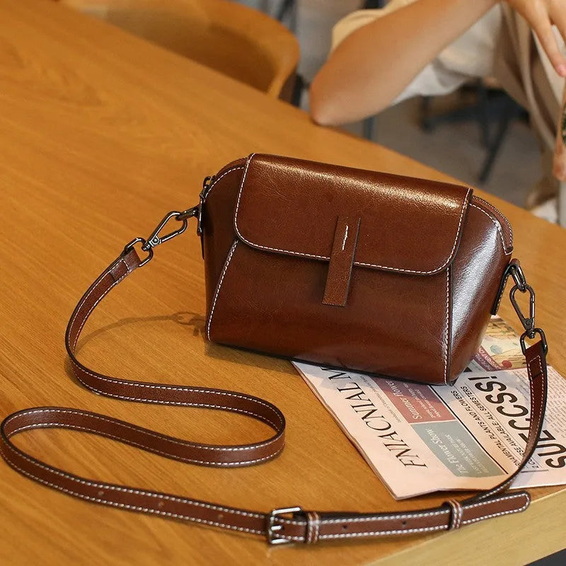 Women's brown oil wax leather messenger bag with crossbody strap and multiple internal pockets