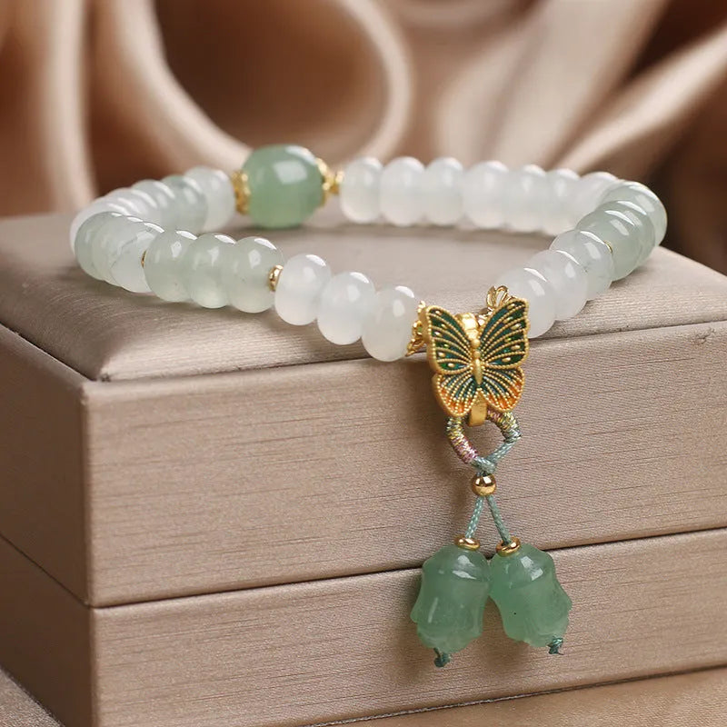 Green crystal abacus bead bracelet with retro butterfly tassel and pearl accents on a 17cm chain.