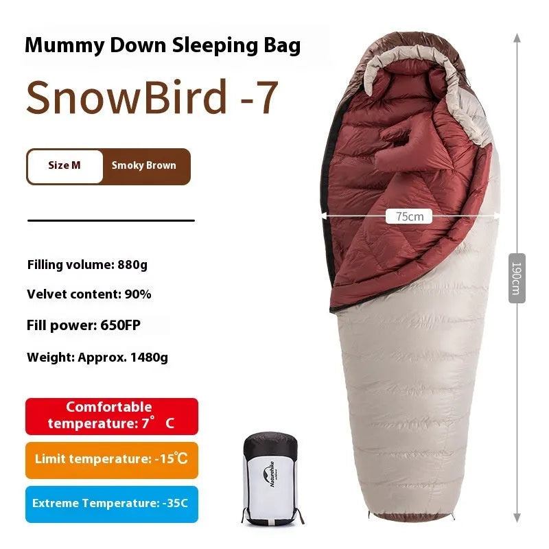 Adult mummy-style sleeping bag with goose down insulation shown with its storage bag.