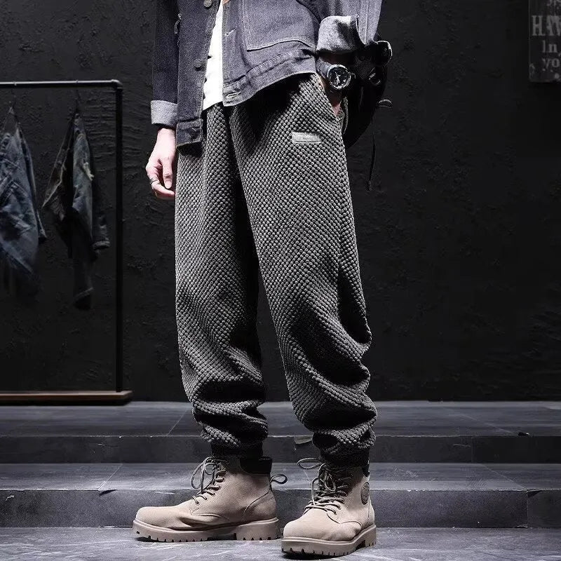 Men's grey straight leg sweatpants with an ankle-tie closure, laid flat.