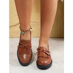 Women's brown and black bow-detailed flat loafers made from artificial PU, shown from the side.