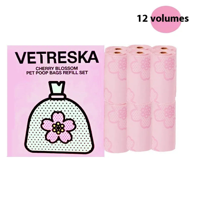Portable dog poop bag dispenser capsule in strawberry, orange, and cherry blossom patterns with a roll of scented bags.