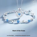 Blue diamond heart-shaped necklace and matching bracelet set with gemstone inlays on a model