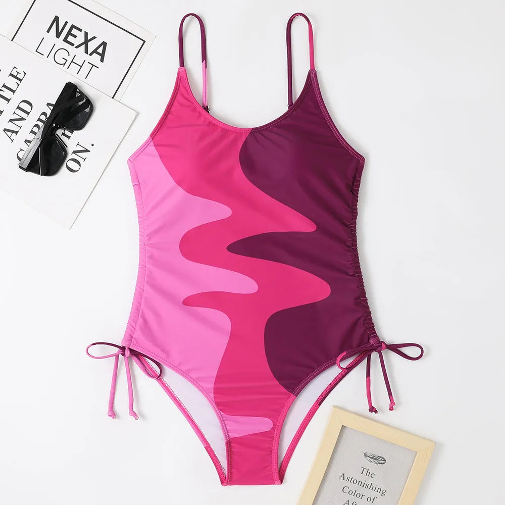 Women's sleeveless one-piece swimsuit in blue with backless design and striped pattern
