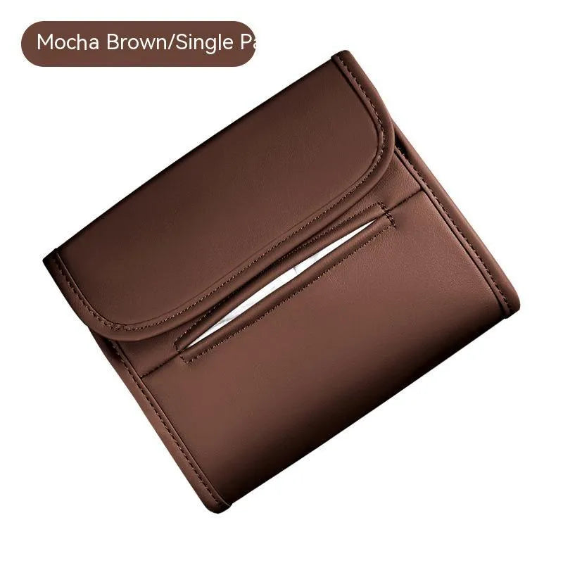 Leather car tissue box mounted on a car sun visor with elastic band strap.