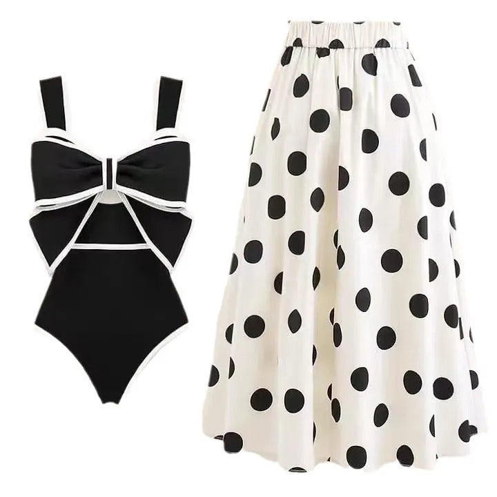 Female one-piece swimsuit with round skirt and bow detail in black or white polyester fabric for swimming and beach wear