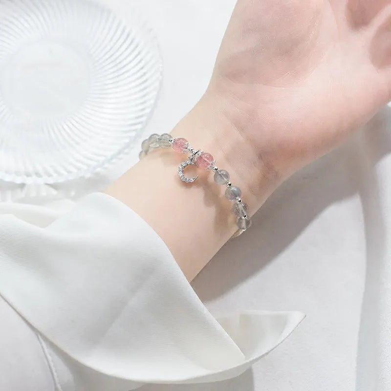 Handmade silver-tone adjustable bracelet with a 6mm moonstone bead and a small crescent moon charm.
