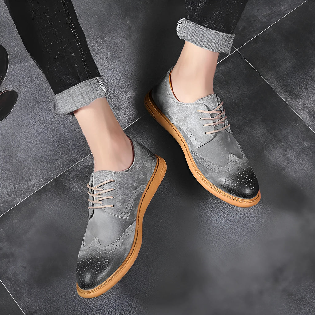 Men's black genuine cowhide business lace-up shoes with leather toe cap on a grey background.