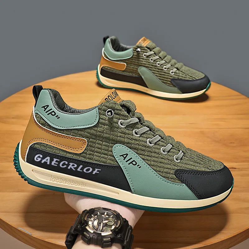 Men's low-top green mesh running shoes with white laces on a grey sole