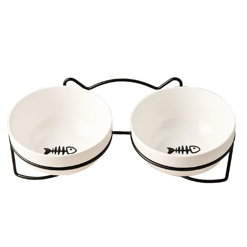 White ceramic pet bowl with cat paw print pattern in black iron frame stand