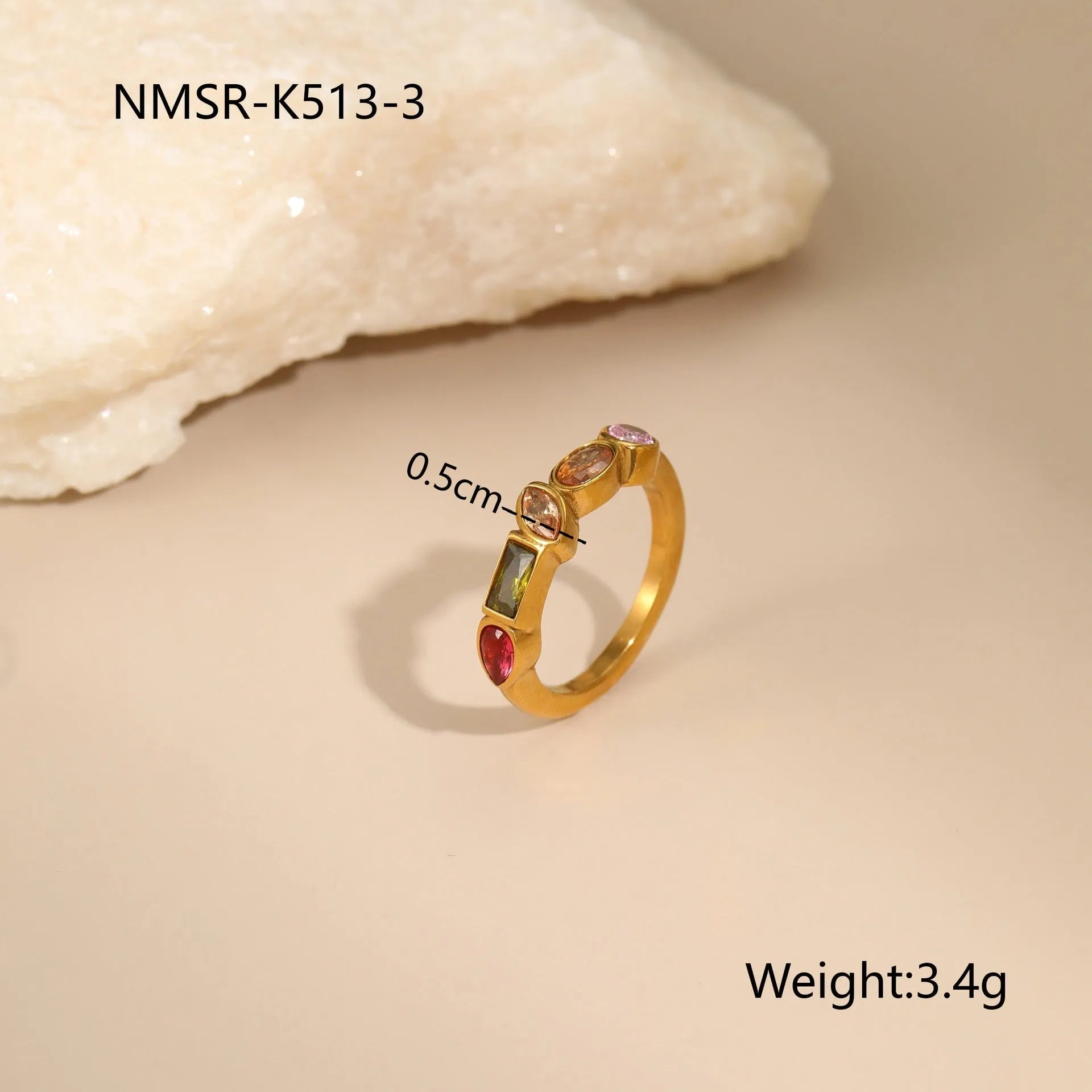 Geometric gold plated jewellery set with colour zircon necklace, ring, and earrings on a white background.