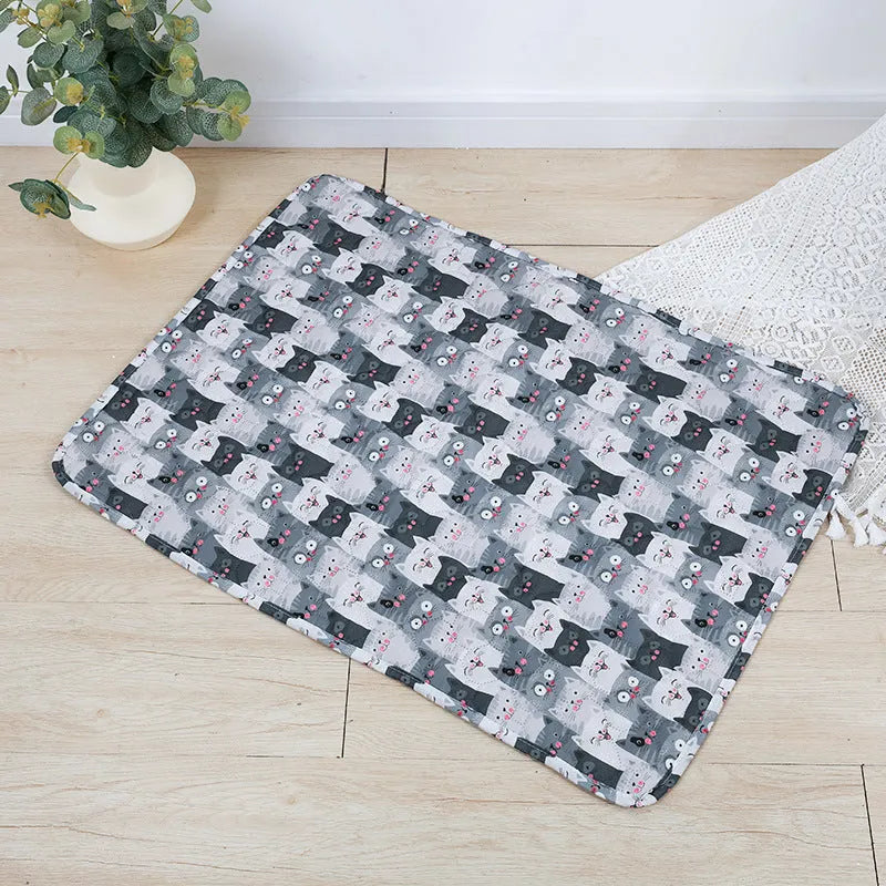 Reusable washable pet urine pad with colourful animal print and waterproof non-slip backing.