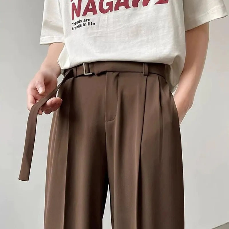 Black straight leg wide trousers on hanger showing loose fit and non-ironing fabric