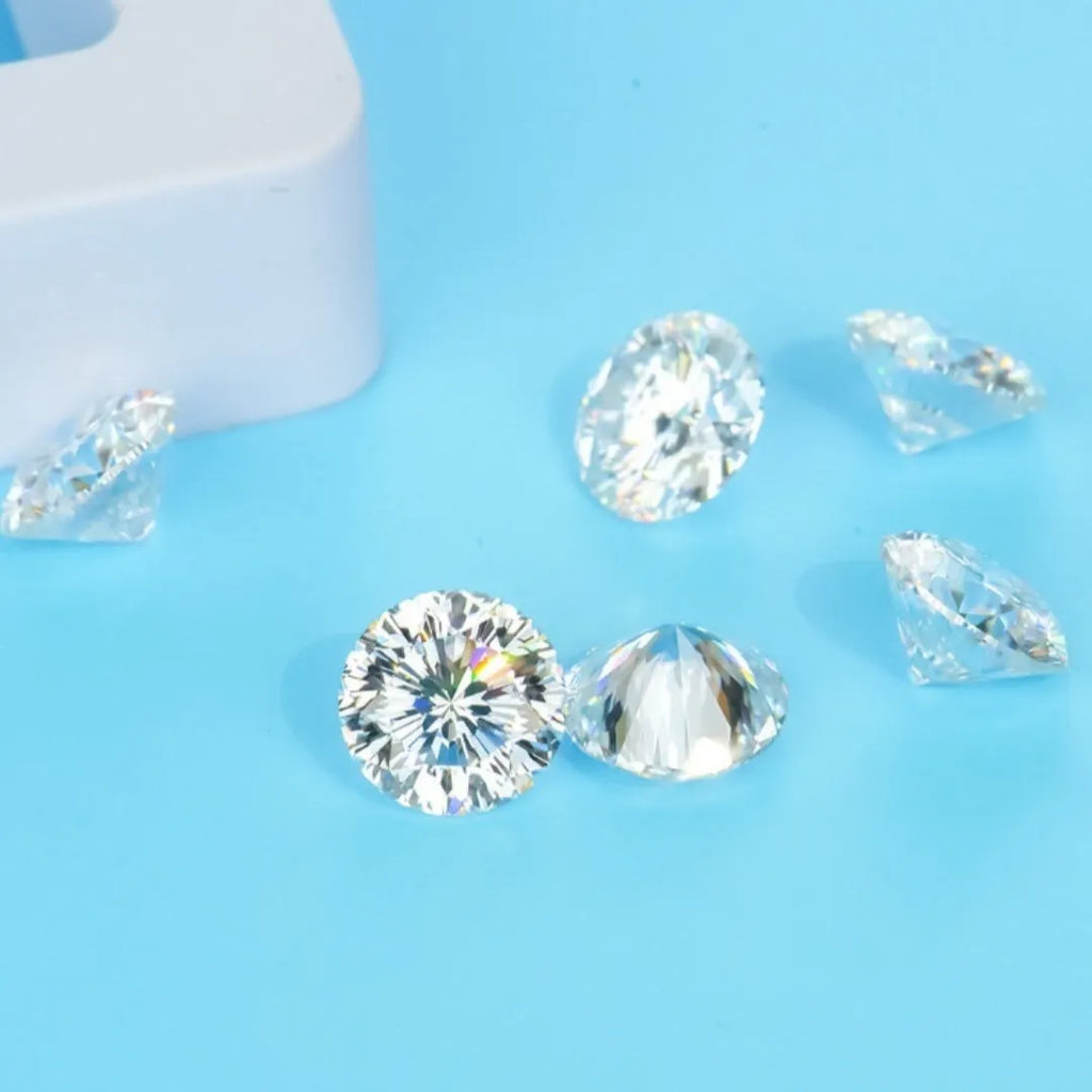 Round moissanite loose gemstone with eight hearts and eight arrows cut on a white background.